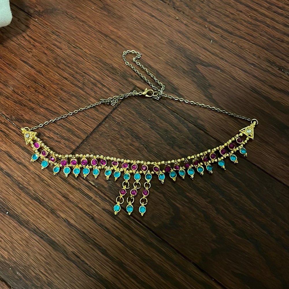 Gold statement necklace with purple and blue diamonds